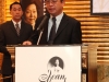 man speaking behind podium