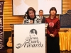 women speaking behind podium