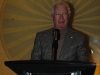 man speaking behind podium