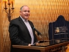 man speaking behind podium
