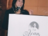women speaking behind podium