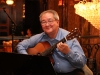 man seated playing guitar