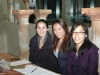 three students seated behind table