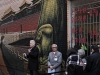 man speaking in laneway to crowd of attendees