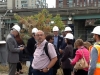 Crowd of people with several construction workers in hard hats.