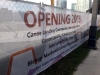 Large sign attached to chain link fence describing Jean Lumb Groundbreaking Event.