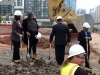 People walking around dirt contruction site.