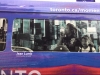 purple and red van with Jean Lumb poster on the window parked outside a home
