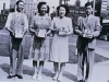 two men and two women in formal attire holding small boxes to fundraise