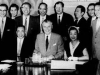 Jean lumb sitting at conference table signing documents with prime minister Diefenbaker