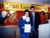 Jean Lumb posing for photo onstage with man