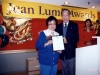 Jean Lumb posing for photo with man holding an award