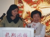 two women standing behind podium
