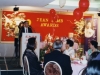 banquet hall with guests seated at tables, red walls with Jean Lumb banner and balloons
