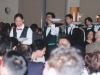 servers carrying plates with sparklers to guests