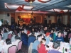 large banquet hall full of people seated at round tables