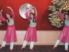 children dancing in pink costume arms are stretched over their heads
