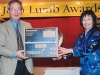 man holding prize, a dvd player