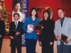 people standing together for photo holding awards