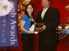 Tstudent being presented with award plaque