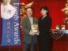 student being presented with award plaque