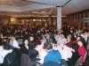 large banquet hall full of people seated at round tables