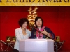 two women speaking behind podium