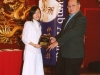 student being presented with award plaque