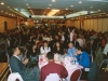 large banquet hall full of people seated at round tables