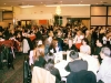 large baquet room full of people seated at round dinner tables
