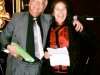 two people laughing and smiling his arms over her shoulder