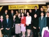 people grouped together onstage for a picture under Jean Lumb banner