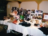 table with pictures, shirts and gift bags for raffle