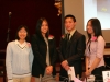 four people standing together for a picture