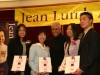 five people holding their awards while posing for photo