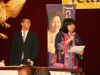 women speaking into microphone and holding a sheet of paper