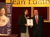 award winner holding her plaque next to gentleman
