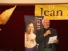 man holding microphone and sheet of paper