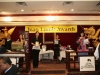 stage with Jean Lumb banner, podium, raffle dispenser and tables with prizes
