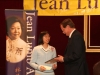 man handing award plaque to  student