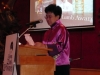 women standing speaking behind podium