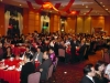 large formal banquet hall, full of round tables, and people seated for dinner