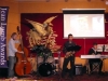 musicians performing onstage, with stand-up bass, drums, keyboard, and saxophone