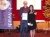 presenter handing award to winner next to Jean Lumb banner