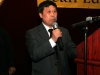 gentle in holding mircrophone at podium