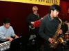 jazz group performing with saxophone, keyboard, drums and guitar