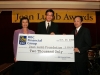 three people holding giant sized check from RBC