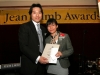gentleman handing female award winner her plaque