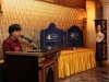 women standing at podium with  large plaques visible behind her
