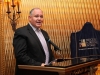 man standing speaking at podium